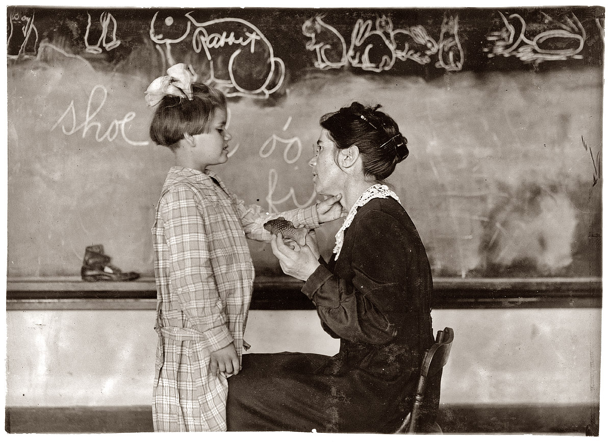 April 1917. "Teaching a deaf-mute to talk. Training School for Deaf Mutes. Sulphur, Oklahoma." View full size. Photograph by Lewis Wickes Hine.