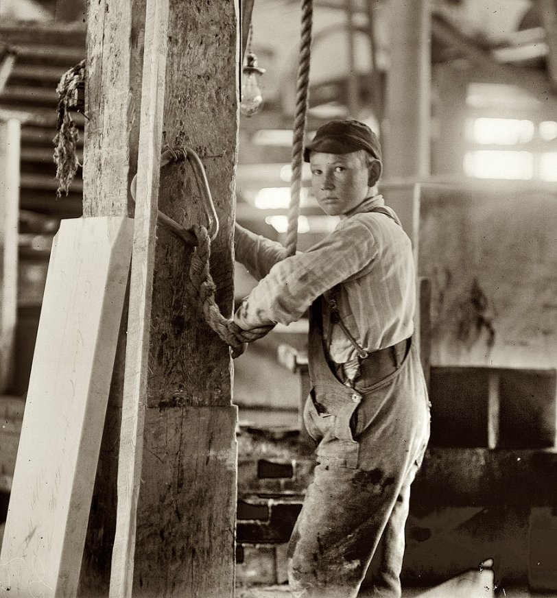 Photo of: Vermont Marble: 1910 -- September 1910. Boy running a hoist at Vermont Marble Company in Center Rutland. View full size. Photograph by Lewis Wickes Hine.