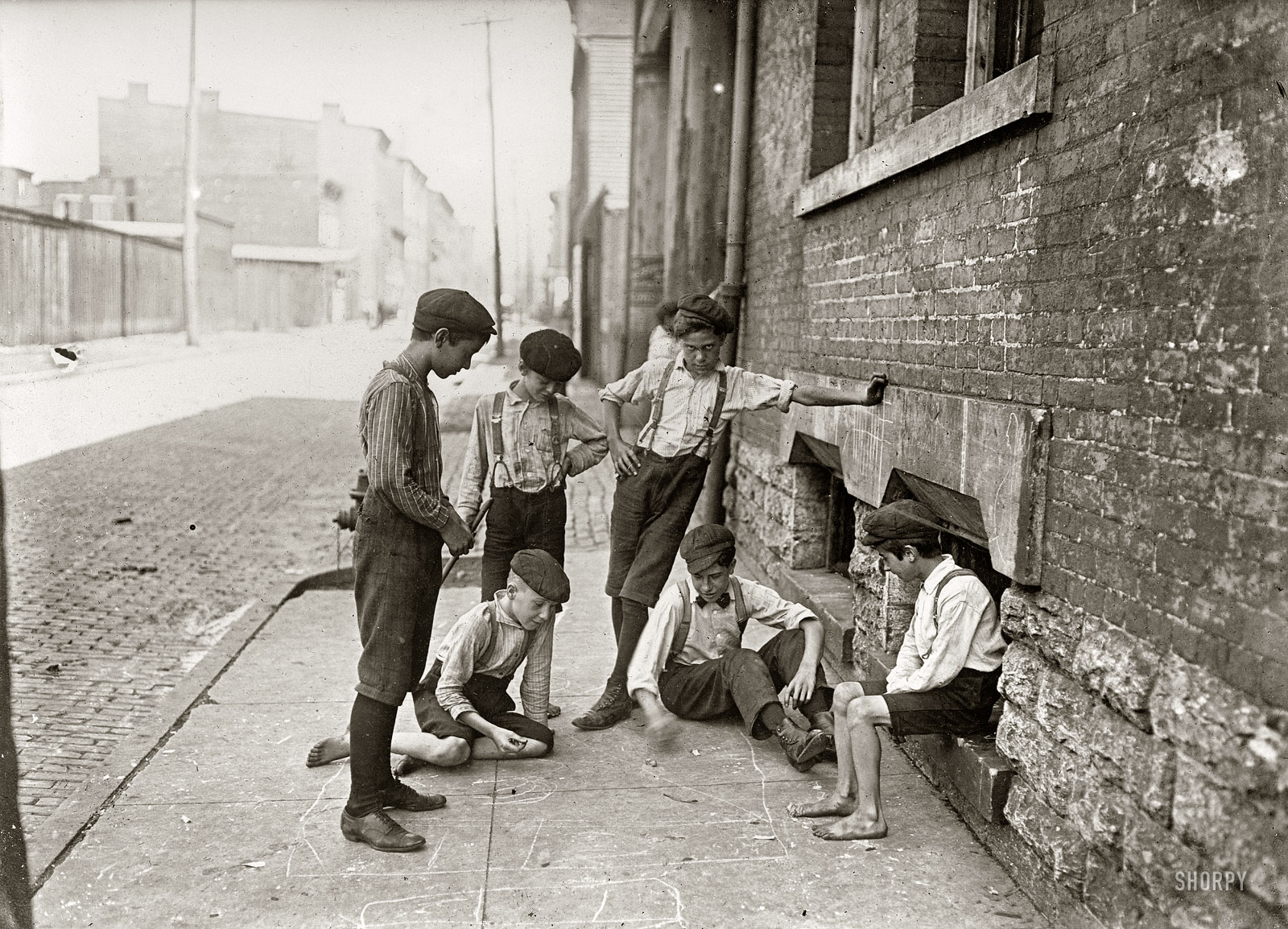 "Game of craps. Cincinnati, Ohio. August 1908." Back in the good old days when kids made their own low-tech fun. Photo by Lewis Wickes Hine. View full size.