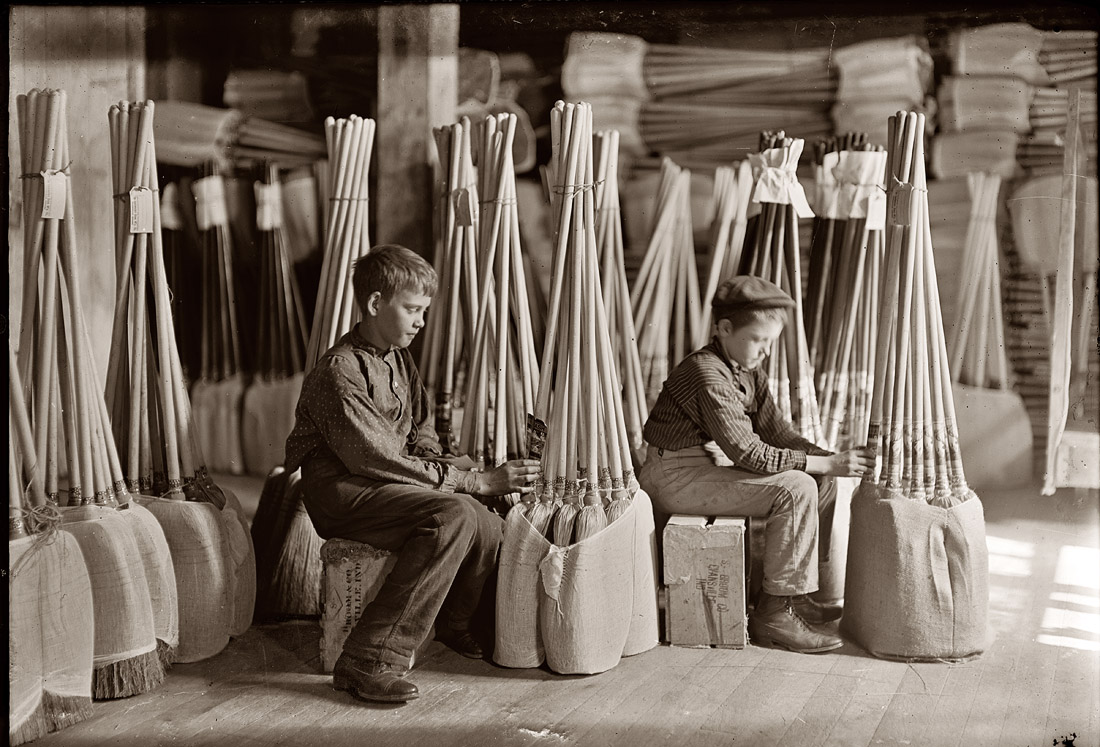 Boys with brooms in the packing room of S.W. Brown Manufacturing, Evansville, Indiana. October 1908. View full size. Photograph by Lewis Wickes Hine.