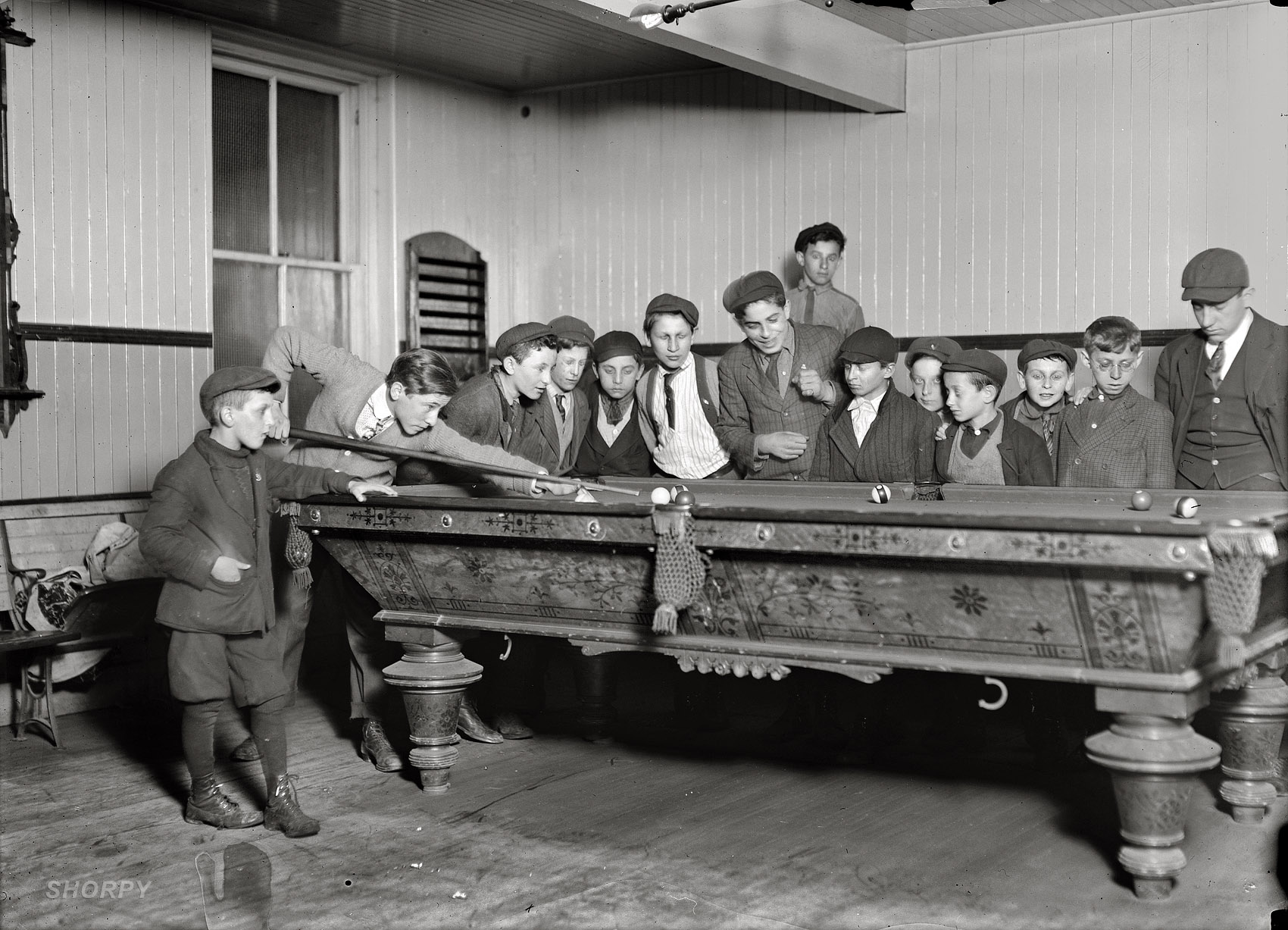 March 1909. "One way to control the street boys. A common scene in the Bancroft-Foote Boys Club, New Haven, Connecticut." View full size. Photograph and caption by Lewis Wickes Hine.