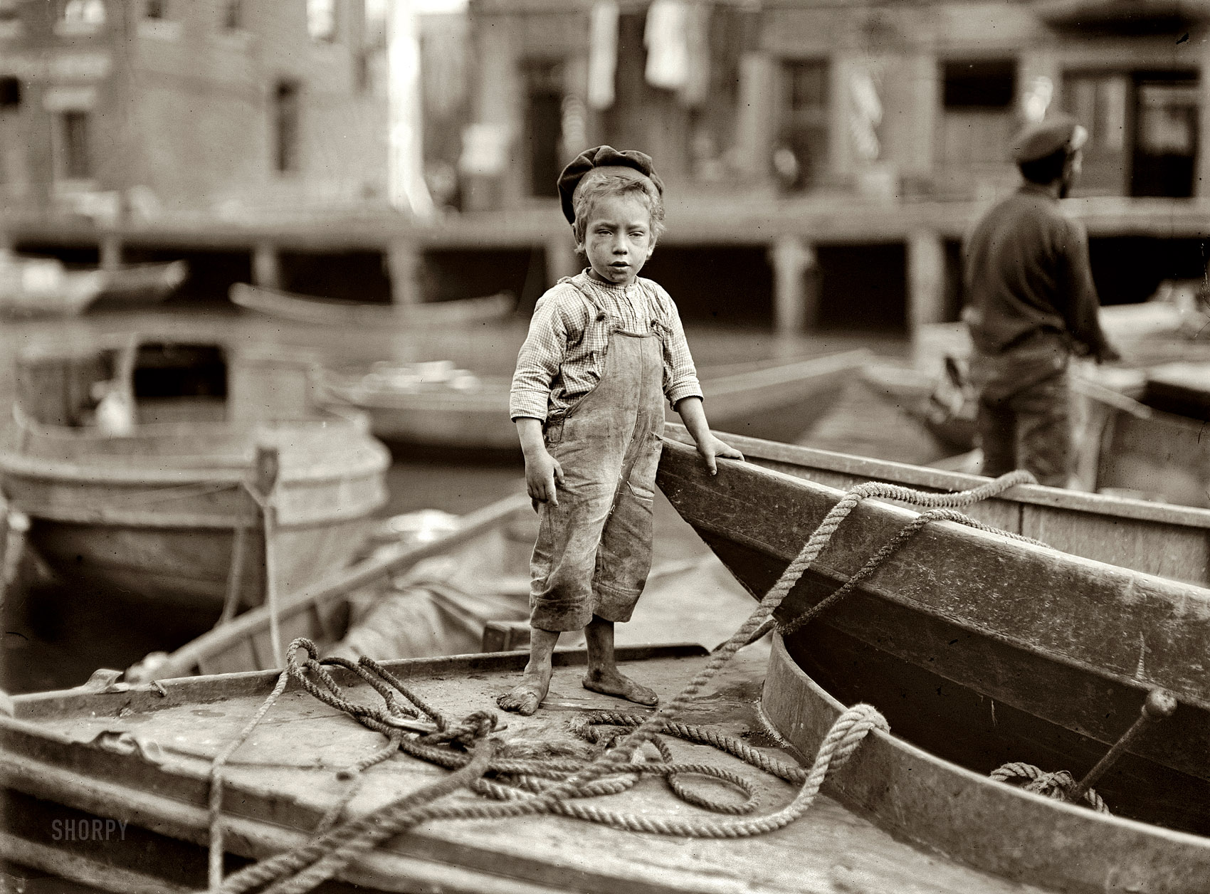October 1909. Boston, Massachusetts. "Truant hanging around boats in the harbor during school hours." Photgraph by Lewis Wickes Hine. View full size.