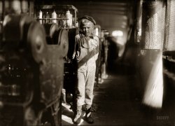 November 1910. Birmingham, Alabama. "Donnie Cole. 'Our baby doffer,' they called him. This is one of the machines he has been working at for some months at the Avondale Mills. Said, after hesitation, 'I'm 12,' and another small boy added, 'He can't work unless he's twelve.' Child labor regulations conspicuously posted in the mill." Photograph and caption by Lewis Wickes Hine. View full size.