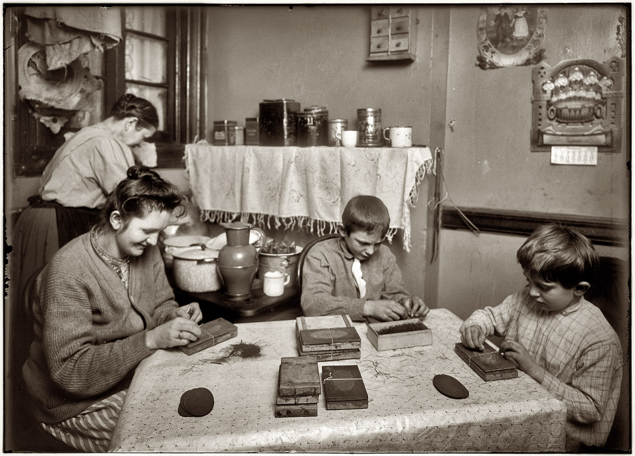 6 p.m., January 31, 1912. "Making hair-brushes. Hausner family, 310 East 71st Street, New York. Frank is 6 years old and John is 12. The mother had a sore throat and wore a great rag wrapped around it, but she took it off for the photo. They said they all (including the 6 yr old) worked until 10 p.m. when busy. Their neighbor corroborated this. She said, 'It's a whole lot better for the boys than doin' nothin'.' The mother said the night work hurts their eyes and John said so too. He was not very enthusiastic about the beauties of work. All together, they make about $2 a week. Father is a motorman." Photo and caption by Lewis Wickes Hine. View full size.