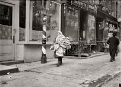 New York, February 1912. "A load of kimonos just finished. Girl very reticent. Thompson Street." Photograph by Lewis Wickes Hine. View full size.