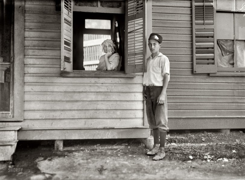 October 1913. San Antonio, Texas. "Sixteen-year-old messenger boy making delivery to 'crib' in Red Light." Photo by Lewis Wickes Hine. View full size.
