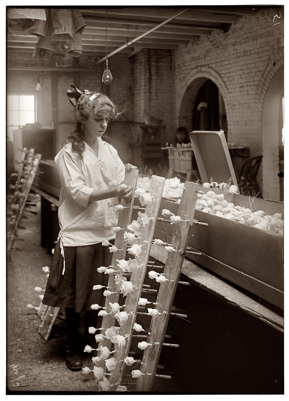 "Margaret Ciampa, 14 years old, finishing flowers at Boston Floral Supply Co., 347-357 Cambridge Street. Said to be the only flower factory in Massachusetts." January 29, 1917. View full size. Photograph by Lewis Wickes Hine.