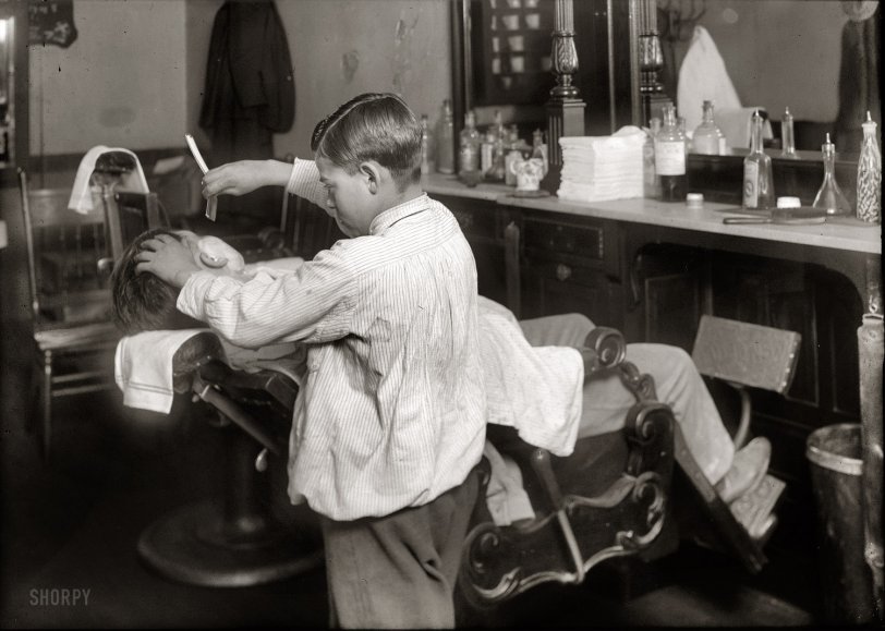 February 1, 1917. Boston, Massachusetts. "Frank De Natale, a 12-year old barber. Lathers and shaves customers in father's shop, 416 Hanover Street, after school and Saturday." Photograph by Lewis Wickes Hine. View full size.
