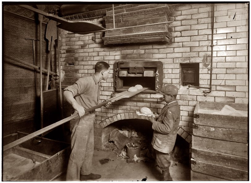 February 1, 1917. "Vincenzo Messina, 15 years old, and brother Angelo, 11 years old, baking bread for their father at 174 Salem Street in Cambridge, Massachusetts. Vincenzo is working nights now. Angelo helps a great deal, tends store and helps bake, too." Photo by Lewis Wickes Hine. View full size.