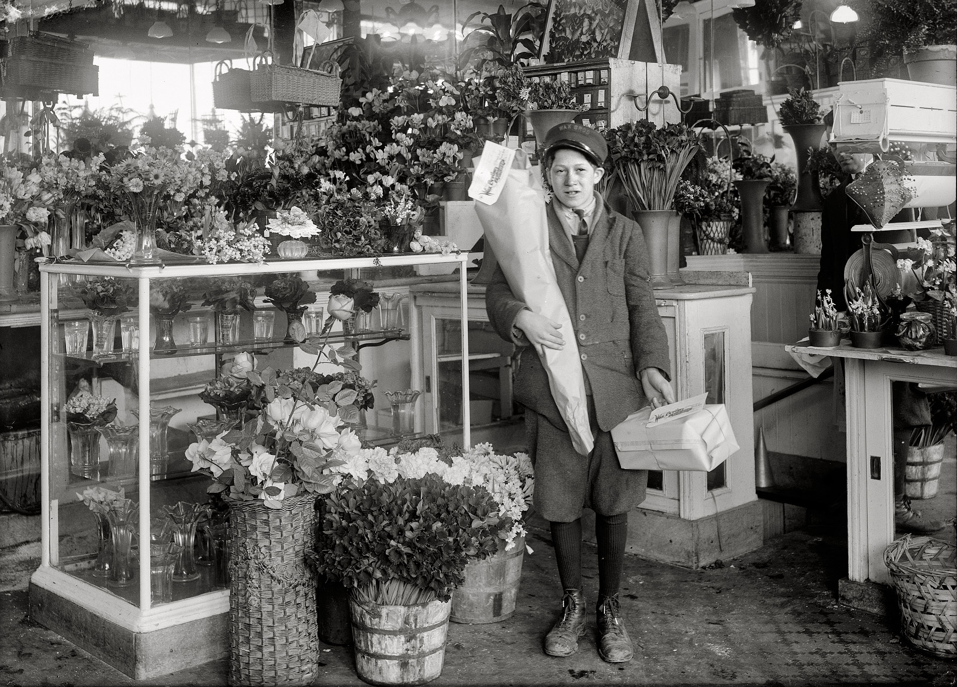 February 2, 1917. Boston, Massachusetts. "Abe Singer, 14-year old helper at Wax Florists, 143 Tremont Street. He delivers bundles, tends the door, etc." Photograph and caption by Lewis Wickes Hine. View full size.