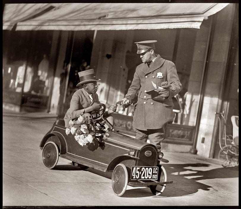 "Louise and flower shop auto." February 5, 1922. (Yes, it really does say Louise on the hat. We have a different photo we'll post tomorrow.) "Louise" is tootling along the sidewalks of Washington in a battery-powered Custer Car very similar to the one being driven by Miss Bay. National Photo Co. Collection. View full size.
