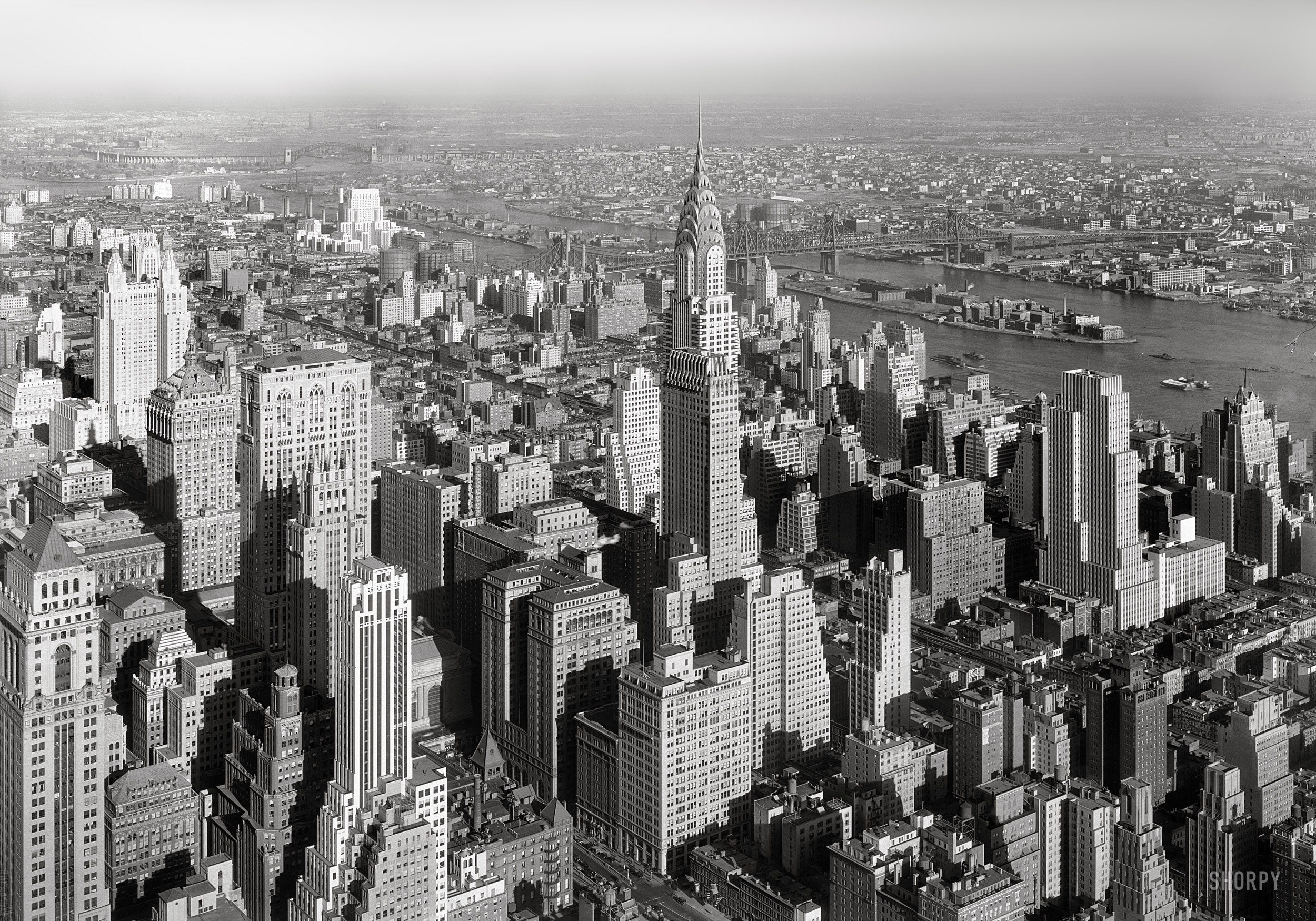 Jan. 19, 1932. "View from Empire State Bldg. to Chrysler Building and Queensboro Bridge, low viewpoint." 5x7 negative by Gottscho-Schleisner. View full size.