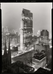 New York. December 5, 1933. "Rockefeller Center and RCA Building from 515 Madison Avenue." Digital image recovered from released emulsion layer of the original 5x7 acetate negative. Gottscho-Schleisner photo. View full size.
City of the godsIn 1933, my father was a seven-year-old living up Lick Branch Hollow in the Ozark Mountains. He would read books by kerosene light in the evenings. His family kept butter and milk (and Uncle Linus' hooch) in the cold spring-fed creek outside their house. It's astonishing to think he could have boarded a train and eventually arrived in this city of the gods, only a thousand miles away.
Sign of the CrossThe double bar cross was the emblem used by the  National Tuberculosis Association. Wonder if the lights were part of the campaign to fight TB.
Gotta love those whitewalls!On the convertible by the front door. Double O's. Looks like it's ready to go somewhere in a hurry.
Released emulsion layer?Dave, can you explain the technology of this image? How does an emulsion layer get released from a negative?
[This is a process used on deteriorating acetate transparencies and negatives when they've begun to shrink. The negative is placed in a chemical solution that separates the emulsion from the film base. The released emulsion layer (the pellicle) is then placed in another solution to "relax," or unwarp, it. It's kind of like disappearing your body so that only the skin is left. More here. - Dave]
Amazing viewThe shot is incredible!  It looks almost surreal.  I love it!
Awesome scan job.I only wish I could see an even higher res version. Great work bringing this one back to life.
WowI just can't believe how beautiful this shot is.  Looks like the view from my New York Penthouse sitting there drinking martinis and listening to that new "jazz" music.
High DramaThis marvelous building, reaching for the sky as if erupting from the ground, combines amazing delicacy, impressive size, and a feeling it is built for the ages to admire. SO much more breathtaking than today's typical glass box, although you need a view like this to really appreciate the classical lines and artful massing. A nice complement to the gothic cathedral in the foreground - a true temple of commerce!
Churchly And Corporate SpiresThat's St. Patrick's Cathedral on the lower left, probably the only building from the 19th century left on Fifth Avenue, except for the Chancery House that's attached to it.
Both styles of architecture are very dramatic. When I was a small child, at Christmas, my family would go to the Christmas Pageant at Radio City Music Hall every year, and then attend Midnight Mass at St. Patrick's.
Ever since, I've never been able to separate religion from showbiz. Possibly because they really are the same thing.
Take a peekThis picture makes me want to get out the binoculars and look in the windows.
&quot;Don&#039;t get much better&quot;This image is a about as close to textbook perfect BW as you will find. It contains the complete range of grays from what looks like solid black in a few places to solid white in the highlights. The camera was level and the focus was dead on. As a photographer, I am envious.
Old shooter 
Reaching New HeightsThe skyscraper is 30 Rockefeller Plaza before the RCA and current GE neon signage. Not that it wasn't famous before, but the TV show "30 Rock" has made it an even more iconic. Another claim is the gigantic Christmas tree on the Plaza, between the building and the skating rink, that when illuminated kicks off the Holiday Season in NYC.
Hugh FerrissThis is like the photographic equivalent of one of Hugh Ferriss' architectural drawings, coincidentally of roughly the same era.
MagicThe quality of this incredible photo captures the magic that New York City always longs for but seldom delivers.
King Kong might have had  a chance...had he chosen 30 Rock instead.
OKLo mismo digo.
Gracias.
American Express BuildingThat hole in the ground, I believe, bacame the American Express Building.  If you come out of the subway at the Rockefeller Center stop, and come up on the escalator in that building, you get an incredible view of St Pat's from below, with the spectacular statue of Atlas in the foreground as well.  Very cool.
Other noteworthy background details here include the Hotel Edison, and the old NY Times Building, at Times Square, before they went and utterly ruined it in the 60's by stripping all the detail off the skeleton.
And check the skylights on the roof of what I think is the Cartier store, in the foreground! 
Send this to Christopher NolanHere's the art direction for the next Batman sequel.
SpectacularWhat a wonderful, wonderful image! I love coming to Shorpy because you never know what Dave will come up with next.
Thanks so much!
The GreatestDave, this has to be one of the greatest photos you have posted. I work around the corner, and can look out my window at 30 Rock from 6th Avenue... my building wasn't built until 1973. Thank you.
Time stoppedIs it 2:25am or 5:10am?
Can you spot the clock?
What Gets MeLooking at this photo - and it looks spectacular on my new monitor - is the sky. It has a sort of foggy twilight quality that is difficult to put into words but which emphasizes the the "star" of the photo - the RCA Building - and its nearby consorts or supporting cast over the buildings in the background which seem to fad into the mist. 
The building seems like the height of modernity, and one can easily imagine a couple of kids from Cleveland named Siegel and Shuster seeing this and making it a model for the cities of the doomed planet Krypton.
Very neat picture...Can you give us an idea of what it looked like before it was restored?
[There's an example here. - Dave]
StunnedWhat a totally wonderful image,  Sat here slack jawed at the incredible detail and the superb composition.  
I am amazedThe detail in the spires at St. Paul's Patrick's is fantastic. The amount of work that went into that building must have been enormous. I am very grateful not to have been on the crew detailed to put the crosses atop the spires!
The Future Is NowInteresting that this photograph looks into a future in which many of the same buildings are still with us. At far left midground is the tower of Raymond Hood's American Standard Building. Next to it, with the illuminated sign on top, is the New Yorker Hotel (now Sun Myung Moon's) where Nikola Tesla spent the last ten years of his life. At center is the N.Y. Times Building with its flagpole convenient for deploying the New Year's Eve ball. And last, but not least, the Paramount Building topped by a globe and illuminated clock which is about as close to the Hudsucker Building as could hope to be seen. Of these four only the appearance Times Building has changed to any extent.  A wonderful slice of time. 
TremendousTwo of my favorite photos on Shorpy consist of those like this one, showing the immense power of a huge city, even in the depths of the Depression, and those of small towns, especially when patriotic holidays were still celebrated.
Samuel H. GottschoI'd never heard of him, but one look at this photo and I'm instantly a fan.  This image is nothing short of spectacular.  
Ethereal, PowerfulThere have been many photos on this site that have impressed and pleased me, but this one is one of my favorites. Absolute magic. It's the quintessence of the power and style of 1930s design.
Time machineI admire NY photos of the 1950s. And now I see that many of the buildings in NY I admire already were erected in early 1930s! What a discovery. What a shot.
The Singularity of the MomentThis is an amazing photograph.
As one earlier contributor observed, the pure technical aspects of the black and white composition are fabulous. The spread of detailed gray shadows and whites make this photo almost magical. It has the qualities of an Ansel Adams zone photograph that makes his work so arresting.
But what really makes this photograph dramatic is what it reveals about New York City in 1933.
A vision of the future of large cities, bustling twenty four hours a day and electrified. Today visions such as these can be seen on any continent in any large city.   It has become the norm. But in 1933 there were only two places in the world that looked like this: New York City and Chicago.  
One can vicariously put oneself into the shoes of some kid from rural America or from Europe setting on Manhattan Island and seeing visions such as these for the first time. I can only guess it had the same effect as it had on 14th-century peasants in France, visiting Paris for the first time and entering the nave of the Notre Dame Cathedral.
Beautifully put!I'm sure Samuel Gottscho would have been very gratified to know thoughtful and eloquent people like Bob H would be appreciating his work in the 21st century.  
PenthouseIs the Garden Patio still across the street from the skylights?
I am in love with this photographExquisite doesn't even begin to describe it.
In Your Mind&#039;s EyeYou can smell and feel the air and hear the traffic.
It may be calm now...I have a feeling that all hell is about to break loose -- this picture was taken the day Prohibition was repealed. 
I worked hereI worked here in the 1960s for the "Tonight" show unit as as a production assistant for Dick Carson, brother of Johnny Carson. An attractive, dark-haired woman named Barbara Walters was working at the "Today" show at the same time. She is about 10 years older than I am. 
I also worked with the News department for a time. I was in the elevator with David Brinkley coming back from lunch when I learned that President Kennedy had been shot. We stayed up all Friday night and most of Saturday assembling film footage for a retrospective of JFK's life. When we weren't editing, we were visiting St. Patrick's Cathedral to light candles with others in the crowd. 
That's an absolutely amazing photo. I'm going to link this to other New Yorkers and broadcasters who might be interested.
Thanks for all your work. 
Cordially, 
Ellen Kimball
Portland, OR
http://ellenkimball.blogspot.com
30 RockIs the excavated area where the skating rink is? I've been there once and it is very magical. Right across the street from the "Today" studio.
Tipster&#039;s PhotoStunning, but in a different way than Gottscho's. It helps when the subject is beautiful.
30 Rock 09
Here's the view today made with a 4x5 view camera, farther back seen through the St. Patrick's spires and somewhat higher than the 1933 photo. Lots more buildings now. I was doing an interior architectural shoot, and went out on the terrace of a wedding-cake building on Madison Avenue. It was after midnight. Not much wind. Strangely quiet.
As an architectural photographer I have great admiration for these Gottscho pictures.
30 Rock in Living ColorThat's a lovely photo, and it's nice to see the perspective so close to that of the original.
Design Continuum of Bertram GoodhueThe proximity of St. Patrick's Cathedral to the newly constructed tower by Raymond Hood brought to mind two "bookends" to the unfulfilled career of Bertram Goodhue.  During his early apprenticeship he undoubtedly worked on the St. Patrick's Cathedral, in Renwick's office, which greatly influenced his early career and success.  The tower (30 Roc) represents what might have been...rather what should have been the end result of Goodhue's tragically shortened career (ending in 1924).    Hood's career, which began to  emerge after Goodhue's death is far better known, but is greatly in his debt.  Hood's 1922 Tribune Tower clearly displays this link, as a practitioner of the neo-gothic style.  Much of Hood's gothic detail is a through-back to design ideas that by 1922, Goodhue had already left behind.    
Goodhue was by this time already synthesizing elements of european modernism into an new original american idiom.  Goodhue's last major projects were already working out the language of the modern/deco skyscraper; (the Nebraska State capital and Los Angles Public Library the best examples.)  Goodhue's unique career was the crucible where concepts of romantic imagery of the Gothic, the sublime juxtapositions of minimal ornament on architectonic massing was being forged with modern construction technology.  A close study of his career and work will show that not only Hood, but other notable architects of the era built upon the rigorous and expansive explorations that Goodhue was beginning to fuse at the end of his life.  
*It is also curious to me that Hugh Ferris is credited with so much of these innovative design ideas; no doubt he was a super talented delineator, his freelance services were utilized by many architects of the time including Goodhue.  Some of his famous massing studies (sketches) owe much to Goodhue's late work.            
Amazing Execution and RestorationI agree with "Don't get much Better" ! This is as good as it can get for B&amp;W. The exposure is so right-on and this in 1933!! Is this a "night" shot.. there is a lot of ambient light. Simply Amazing. I want it!
Rock RinkThe not-yet-built skating rink is in front of the building. The empty space became 630 Fifth Avenue, where a statue of Atlas stands.
Vanderbilt Triple PalaceA long time since this was posted, but I am surprised no one recognized the southern half of the iconic, brownstone-clad Vanderbilt Triple Palaces in the foreground (640 Fifth Avenue), just opposite the lower edge of the excavated building site.
The northern half, with two residences, had been sold, demolished &amp; replaced a long time ago, but the southern half stood until 1947 (Grace Wilson Vanderbilt continued entertaining in her usual style until WWII).
The entrance vestibule to the three residences featured a nine foot tall Russian malachite vase, once given by Emperor Nicholas I of Russia to Nicholas Demidoff, now on display at the Metropolitan Museum of Art a couple of dozen blocks north on Fifth.
(The Gallery, Gottscho-Schleisner, NYC)