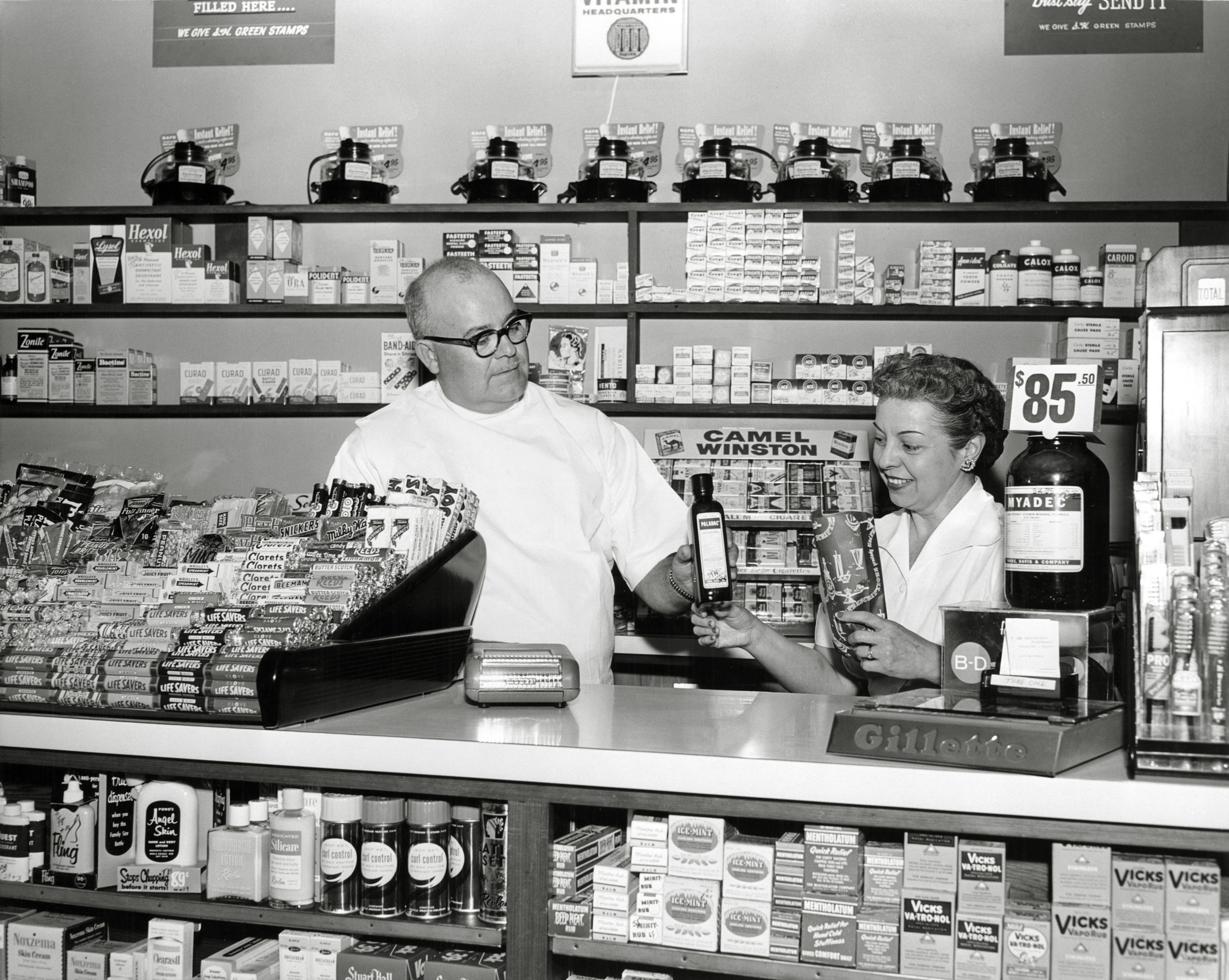 I purchased this 8 x 10 print at the swap meet. On the back is printed:
Mr. and Mrs. Cliff McCorkle, proprietors of the 101 Broadway Pharmacy, Richmond, Calif., getting an order ready for delivery. 5 November 1957. Photographer: Pfc. Barbara A. Warner, Sixth US Army Photo Lab, Presidio of San Francisco, Calif. Official US Army photograph. View full size.