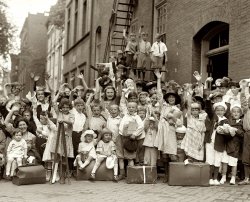 A group portrait with children waving taken on July 24, 1922. The circumstances of the gathering and the location were not recorded, but it was likely taken in the Washington, D.C. area. National Photo Company collection.  View full size.