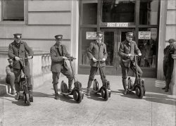 Washington, D.C., circa 1917. "Post Office postmen on scooters." Kind of a Segway vibe here. Harris &amp; Ewing Collection glass negative. View full size.
Cool old scootersEarly Autoped Ever-Ready scooters. They were new in 1914, according to Wikipedia, so that narrows the date of the photo down a bit.
[Thanks! Below: Article from 1914, ad from 1916. - Dave]

I wonderI wonder why these didn't catch on? They look almost identical to some of the *extremely* noisy motorized scooters we have today. Perhaps they broke down, or they made an ungodly racket, or people just weren't so walking-averse as they are today. 
Wonder no more:You hit a small rock or crack in the pavement and over the handle bars you go.  Perhaps too many carriers were going onto the injured list.
Flash in the Pan?Looks like they had the staying power of Segues, also.
Smithsonian has oneIt's here. A 1918 model with some usability improvements but not as spiffy looking.
HuminaThey don't make mailmen the way they used to.
Pretty simple design.Looks like its basically a horizontal shaft engine with the front wheel being attached to the shaft, with some sort of clutch mechanism. Guess it gave mailmen the chance to get away from the local dogs.
ReflectionsIn the window, you can just barely see a sign for the Hotel Harrington (which would put this at least after 1914). That would mean that this could be the post office on Penn between 12th and 13th.
Cool it ain&#039;tDo you suppose these men felt as dorky as they look?
Precursor to SegwayWow, you'd think we would have learned our lesson already. Remember how the Segway was going to change the world? 
I think they are used in Post Offices (somewhere), and I have seen police use them.
Scoot!"Wow, you'd think we would have learned our lesson already. Remember how the Segway was going to change the world?"
Not at $5,000 each (the price that I've seen), they wouldn't.
Special-Delivery MessengersThese aren't regular letter carriers, aka mailmen, but special-delivery messengers. According to Sec. 864 PL&amp;R (Postal Laws and Regulations) of 1913, these could be, at the discretion of the local postmaster, "boys 16 years of age or older." Contemporary Special Delivery postage stamps bore illustrations of such uniformed boys riding on bicycles:

The Mailman ComethI second your comment with a hubba hubba.  Forget the milkman, bring on the mailman!
Scooter spot todayThis was at the Main Post Office (now the National Postal Museum) adjacent to Union Station. Here's the spot today, on North Capitol St. NE.
View Larger Map
(The Gallery, D.C., Harris + Ewing)