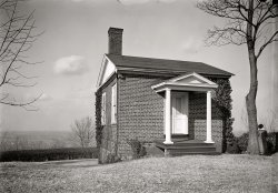Albemarle County, Virginia, circa 1916. "Outbuilding, Monticello. Estate of Thomas Jefferson." This is the North Pavilion, the last building constructed at Monticello. Harris &amp; Ewing Collection glass negative. View full size.
Honeymoon cottageIsn't this the structure in which Jefferson and Martha spent their honeymoon??
[You're thinking of the South Pavilion. - Dave]
North PavilionThe North Pavilion was used as a study by Jefferson's son-in-law. A view of the interior.
Slave Quarters?Or a kitchen perhaps?
[The slave quarters were mostly wood cabins. This was the North Pavilion, the last building constructed at Monticello. - Dave]
Nice view! who&#039;s the Lady?Ar first I thought it was a caped crusader of the 17th century, but wondering who the woman by the tree enjoying the view might be...?

Pre-restorationThis scene is a lot closer to the way it would have been for Jefferson than now, that's for certain.
The North PavilionActually, the North Pavilion is more now the way it would have been than in the early 1900s. The estate was then owned by Jefferson Monroe Levy. The Levys had owned the estate for 70 years at that point and had taken very good care of it, all things considered.  However, at that point the L-shaped North Terrace from the main house had fallen away.  The steps and the door shown here were added to accommodate this, but they weren't there in Jefferson's day.
(The Gallery, Harris + Ewing)