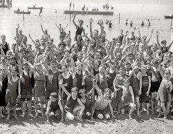 Washington, D.C., 1923. "Opening of Potomac bathing beach." Everyone say "yaaaay!" National Photo Company Collection glass negative. View full size.
Where is the beachMy father grew up in SW Washington in the early 1920s and spoke of going swimming in the Potomac.  I always assumed he meant the channel between Hains Point and the SW waterfront.  Is this picture of that "beach"?  There is sand.
[The Tidal Basin had two municipal bathing beaches. Follow the link in the comment below. - Dave]
Holy Mackerel What a gaggle of boys.
See if you can findeven one overweight kid in the picture.
Good tryThe kid on the left in the front row gave it his best but missed the photographer completely.
MedalistsWhat a great photo...  Whenever I see children, of any era, it makes me wonder about their future and what their lives were like.   They all look so happy here!
Pardon the ignorance but what are the little medals they are wearing around their necks?  Name tags?
[Claim tags for the bathhouse lockers. These are rented swimsuits. - Dave]
Re: See if you can findThe kid in the front row on the right looks a bit husky. 
Segregated Beach?Noting the absence of any person of color, the question has to be asked.
[And has already been asked. Dangling modifier notwithstanding. - Dave]
(The Gallery, D.C., Kids, Natl Photo, Swimming)