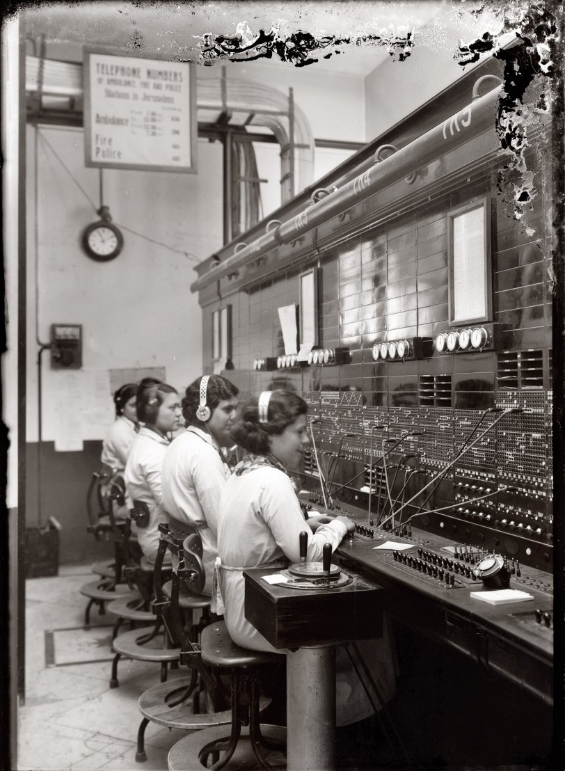 Switchboard operators in 1930s or 1940s British-Mandate Palestine, a few years after the other photo (the chairs look a little less like torture devices). Matson Photo Service. View full size.