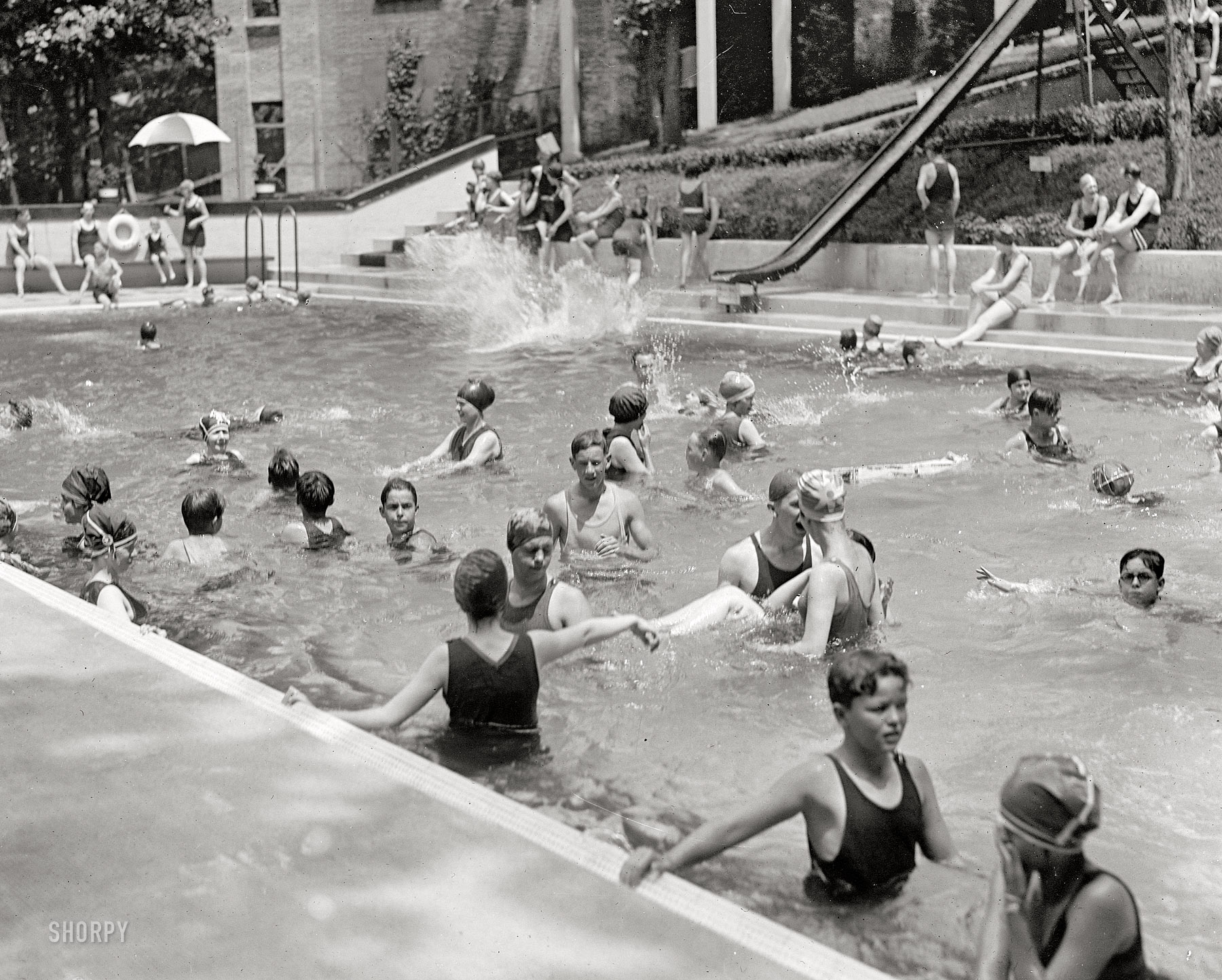 June 26, 1923. Back at the Wardman Park Hotel in Washington, D.C. Taken a year after the pool's opening in 1922, this photo shows the addition of a slide. National Photo Company Collection glass negative. View full size.