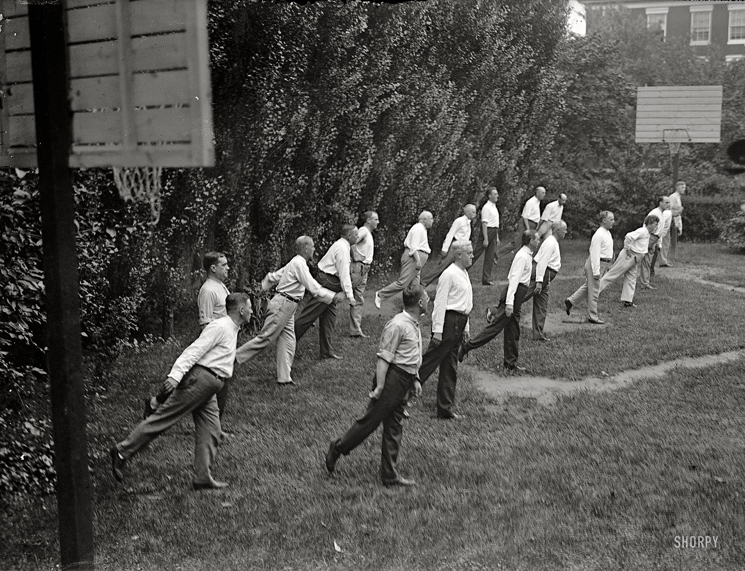 1917. "Walter Camp exercise school. Cabinet officials exercising with other government officials." This seems to have been a manifestation of the "defense league" movement led by former Yale footballer Walter Camp. Anyone up for some miniature base(ket)ball? Harris & Ewing glass negative. View full size.