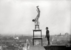 Washington, D.C., 1917. "Reynolds, J., performing acrobatic and balancing acts on high cornice above Ninth Street N.W." Our fourth glimpse of "Jug" Reynolds at work atop the Lansburgh furniture store. Harris & Ewing. View full size.