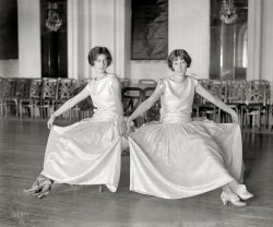 October 15, 1923. Washington, D.C. "Dorothy Mondell, Elizabeth Taylor Jones." National Photo Company Collection glass negative. View full size.
Where&#039;s Lenny and Squiggy?Laverne and Shirley, the Early Years!
What are the odds?Only two guests and they show up wearing the same dress!
Pretty young ladies.
Dot and LizI am thinking that Dorothy was the daughter of Wyoming congressman Franklin Wheeler Mondell and Elizabeth (1901-1968) eventually married Admiral Harry Browning Slocum.
PGThey both get my vote for the rarefied Shorpy "Pretty Girls" category.
In MemoriamFrom Elizabeth's birth date it obvious she saw a lot of history from a lot of places.  Her husband won several combat awards during WW-II including a Navy Cross for his actions during the Battle of Surigao Straits -- a very famous USN victory.
CinderellaDorothy Mondell bears more than a passing resemblance to the Black Widow in Office Xmas Party.
The shoesAre beautiful too!
 Best-Dressed Washington GirlDorothy Mondell: "often spoken of as the best-dressed Washington girl."



Washington Post, Jul 26, 1927.

Mrs. Coolidge to be at Mondell Wedding


Mrs. Coolidge plans to go to Newcastle, Wyo., tomorrow to attend the wedding of Miss Dorothy Mondell, daughter of the former Majority Leader, Frank W. Mondell, to Alexander White Gregg, chief counsel of the Treasury Department. &hellip; President Coolidge wanted to attend but found that he could not get away. It will be a 60-mile auto trip for Mrs. Coolidge.




Washington Post, Oct 25, 1931.

&hellip;
Mrs. Alexander Gregg, who as Miss Dorothy Mondell, was often spoken of as the best-dressed Washington girl, has kept up her reputation for good dressing as a young matron. Recently, Mrs. Gregg wore a tweed mixture dress on  strictly tailored lines and over this she wore one of the ultra modish box jackets of leopard with sleeves coming just below the elbows and the coat ending just above the hips. With this Mrs. Gregg wore a hatter's plush tricorn.




Washington Post, Oct 21, 1941.

Mrs. Dorothy M. Gregg Wed to Maj. Davis in Georgetown


Stealing a march on many of their friends, Mrs. Dorothy Mondell Gregg and Maj. Sherlock Davis were married yesterday morning. A wedding breakfast followed at the bride's home in Georgetown, and they left afterward for Anniston, Ala., where Maj. Davis is on duty at Fort McClellan. Although the wedding was anticipated, it was expected to take place later in the week.
&hellip;
The bride wore a black velvet suit, with epaulettes of braid and a cluster of white orchids. Two clips, of scroll design in three shades of gold, completed the ensemble.




Washington Post, Jun 9, 1944.

Letter is Recountal of Capital 20 years Ago.


A backward look: Charm will out &mdash; even after 20 years. I have a letter to prove it. Signed by Maj. A.H. Hamilton-Gordon who was third secretary at the British Embassy here two decades ago, it came to my desk [Hope Riding Miller] from the War Office in London not long ago. It presents an interesting picture of the Washington-that-was, and also pays tribute to one of the most attractive women who ever belled it around this town.

Here's the letter in part:
&hellip; 
"Myself, I was very fortunate. I had the privilege of escorting to some of the better parties, such as those given by Joe Leiters and Mrs. Harriman of Chevy Chase and the Columbia Country Club, and so on &mdash; a lovely girl, Miss Dorothy Mondell. She was the daughter of Representative Modell, leader of the House of Representatives. I think she married soon after that. Would it be possible for you to tell me whom she married? She was one of the most charming young ladies I ever met &hellip; and I would like so much to know what ever became of her."

For the information of Maj. Hamilton-Gordon. The former Dorothy Mondell did marry, not so long after you left. Her first husband, from whom she was divorced several years ago, was Alexander Gray. She is now Mrs. Sherlock Davis, wife of Colonel Davis, our assistant military attache at Buenos Aires; happily married and having a wonderful time. 



Washington Post, May 12, 1975.

Deaths


On Saturday, May 10, 1975, Dorothy Mondell Frame, wife of C. Wesley Frame, Sister of Frank Mondell. &hellip; Interment Cedar Hill Cemetery. The family requests that memorial contributions be made to St. John's Child Development Center or Christ Episcopal Church Memorial Fund. 
Shades of grayOne dress might be a pale peach and the other a soft mint green or maybe a light blue or mauve. 
No matter the color both the young ladies wear them beautifully. 
Love the shoes!I like their dresses.  They are quite feminine, compared to many fashions from the time. I'd love to see this one in color.  I don't think the dresses were the same color. The shoes are great, too!
ContrastsI am struck by the contrast between these two lovely young ladies and the Young family in that previous offering.  Amazing.  I hope the Youngs did well in their future.
 Not Ordinary Party Girls What a power couple! Miss Jones, granddaughter of Senator James J. Jones of Arkansas. Miss Mondel, daughter of House Majority Leader Frank W. Mondell.  First Lady of the United States, Grace Goodhue Coolidge,  would attend both their weddings: Miss Jones to a Navy officer and Miss Mondell to a top lawyer in the Treasury Department. 



Washington Post, Mar 6, 1924.

Society
Engaged to Lieutenant.


Mrs. James Kimbrough Jones, jr., announces the engagement of her daughter, Miss Elizabeth Taylor Jones, to Lieut. Harry Browning Slocum, U.S.N., stationed on the Mayflower. Miss Jones is the granddaughter of the late Senator James J. Jones, of Arkansas. Lieut. Slocum is the son of Mrs. S.W. Slocum, of El Centro, Calif.




Washington Post, Jun 16, 1926.

Capital Society


Mrs. Coolidge attended the wedding yesterday afternoon of Miss Elizabeth Taylor Jones, Daughter of Mrs. James Kimbrough Jones, to Lieut. Harry Browning Slocum, which took place at 5 o'clock in the Washington Heights Presbyterian church.  &hellip;

(The Gallery, D.C., Natl Photo)