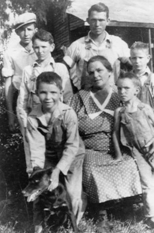 The Griffin family somewhere in Limestone County Alabama. My dad is the one with the frown on his face, he told me he was mad because they wouldn't let him hold the dog. View full size.
