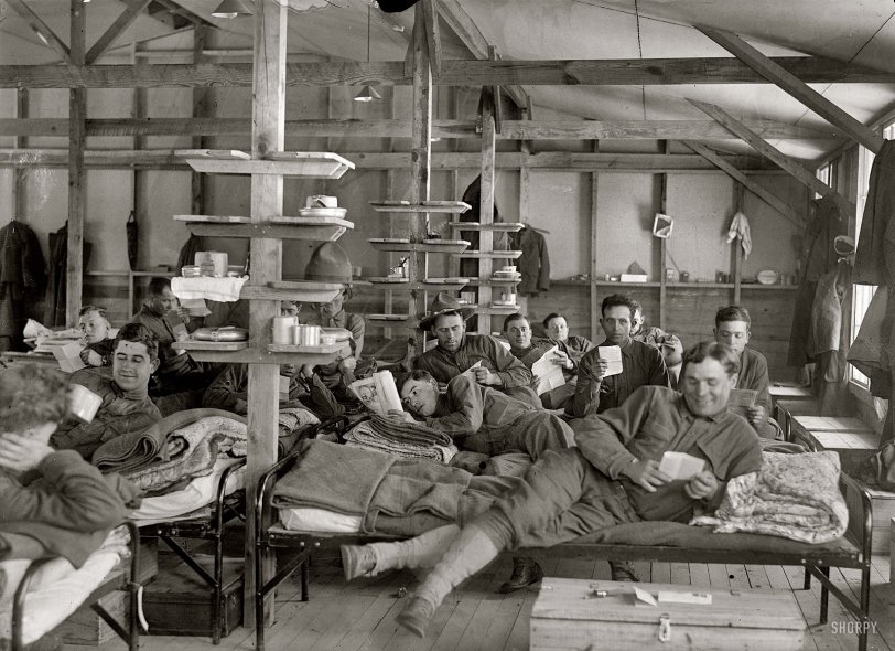 "1917. Camp Meade, Maryland. Winter views." At ease in the barracks with news from the folks. Harris &amp; Ewing Collection glass negative. View full size.
