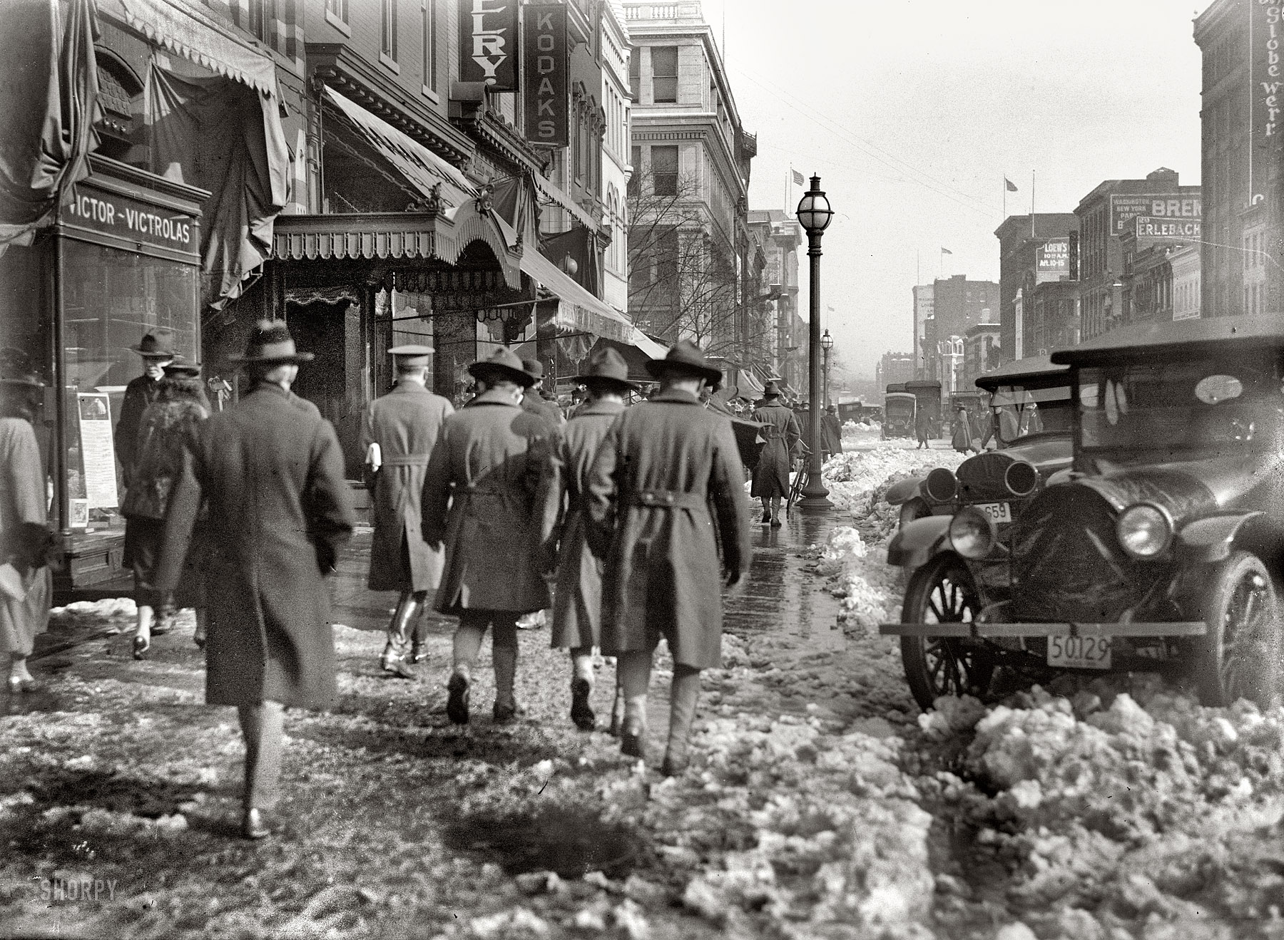 Washington, D.C., circa 1918. "Street scene with snow." More specifically the scene on F Street NW just outside the Harris & Ewing studio, which was over the Victrola store. Harris & Ewing Collection glass negative. View full size.