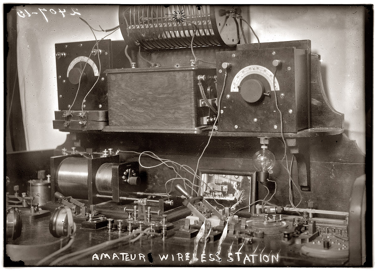 "Amateur Wireless Station" with headset circa 1920. Note photo of the young operator. View full size. 5x7 glass negative, George Grantham Bain Collection.