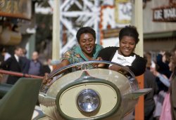 September 1961. Girls on an amusement park ride at Battersea Park, London. 35mm Kodachrome transparency by Charles Eames. View full size.