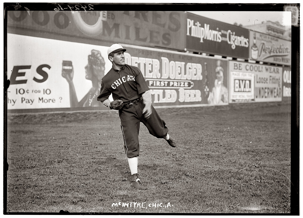 Matty McIntyre of the Chicago White Sox against a backdrop of sales pitches in 1912. View full size. George Grantham Bain Collection.