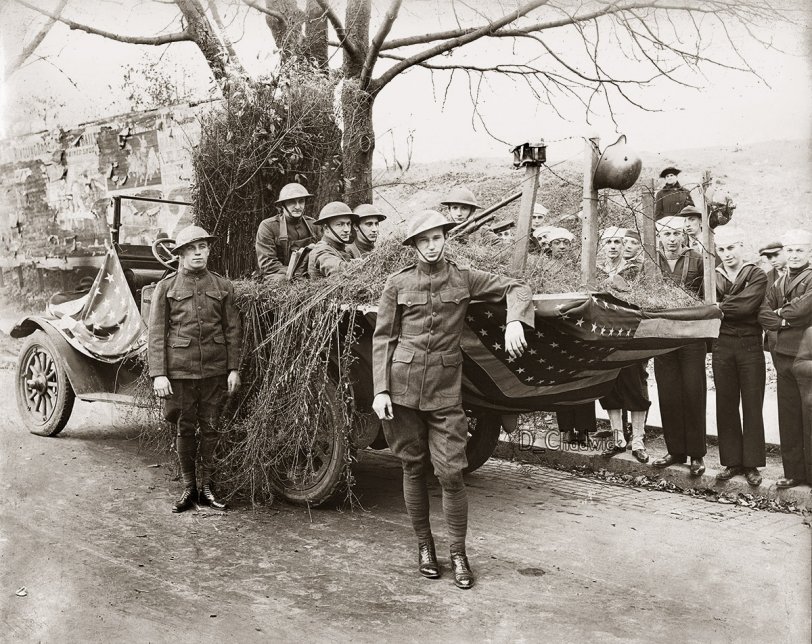 Easton Pennsylvania Armistice Day Parade Float.  A machine gun nest with a Hotchkiss machine gun and German war souviners hanging off the barbed wire posts. Scanned from the original 7.5x9.5 inch print. View full size.
