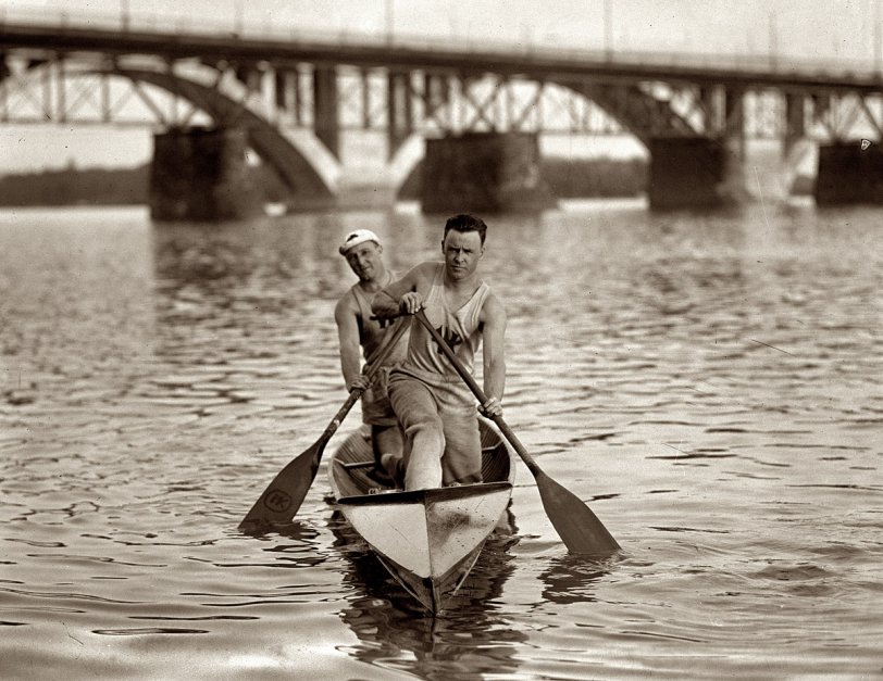 1924. Washington Canoe Club rowers on the Potomac near the recently finished Key Bridge and older Aqueduct Bridge. View full size. National Photo Co.
