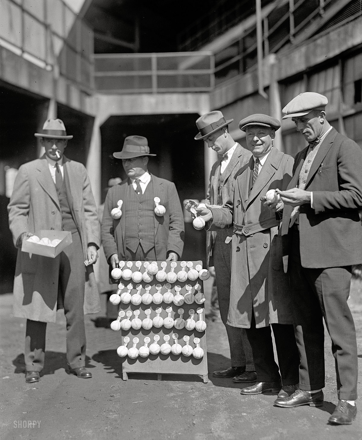 October 1, 1924. "Mogridge, Phillips & Martina buying baseball souvenirs." Washington players George Mogridge and Joe Martina with Nationals announcer E. Lawrence Phillips (2nd from right) at Griffith Stadium three days before the start of the World Series between the Nationals and Giants. View full size.