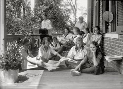 1919. "Young Women's Christian Association. Scenes at YWCA camp." Harris &amp; Ewing Collection glass negative, Library of Congress. View full size.
Bor-ingI've never seen a more bored looking group of people.
Such a happy bunchThe girls in the front are tearing out pages to make paper hats for this equally-festive shindig: https://www.shorpy.com/node/4025.
[That was my first thought, too! Then I realized it was a different house. - Dave]
Nice to be acknowledgedWhat a wonderful photo. I love how the gaze of just one pair of eyes draws the viewer back in for a second look at an otherwise passive scene.
Grandma&#039;s blouseI have a portrait of my grandmother taken the year she graduated, 1919, wearing one of those blouses with the black tie. I love this calm quiet-time scene. 
PicnicLooks like a scene from "Picnic at Hanging Rock."
Only twenty years to goOf course they're bored - it's 1919. They've got the satellite dish but TV hasn't been invented yet.
Single Tasking....My daughter is at a similar age to these girls and were she sitting on this porch she'd likely be on the cell phone, doing a little  texting in between calls, iTouching to check Facebook, to write on someone's "Wall," listening to her MP3 player, and reading a teen magazine while watching TV. 
I think its WONDERFUL that they are taking a break, single tasking, and experiencing a contemplative moment. I expect that in a few moments they will be off for a hike or a rousing game of crochet.
[Or a take-no-prisoners round of croquet. - Dave]
Such Sweet NeglectThis picture is such a nice contrast to the buttoned-up class portraits from the same era we've been looking at recently. Mind you, I'm all for a polished appearance when it's called for, but it's a refreshing change sometimes.
The girls are totally relaxed, their hair is falling our of its confines, their middies are wrinkled, they're slouching and sitting cross-legged, and they're totally happy and charming. It makes me think of the old Ben Jonson poem:
Still to be neat, still to be dressed,
As you were going to a feast;
Still to be powdered, still perfumed;
Lady, it is to be presumed,
Though art's hid causes are not found,
All is not sweet, all is not sound.
Give me a look, give me a face
That makes simplicity a grace;
Robes losely flowing, hair as free;
Such sweet neglect more taketh me
Than all th' adulteries of art.
They strike mine eyes but not my heart.
Ah yes...But wait till the first notes of "Blues My Naughty Sweetie Gives To Me" by Ted Lewis &amp; His Jazz Band blast out of the Victrola. This is gonna become a hot party.
Disk JockeyThink the DJ is spinning the latest Britney CD?
Musical interlude...Cheer up girls, the Charleston is on its way!
Bor-ing?Apparently Anon Tipster would find me colossally boring. Sitting on a porch reading quietly without being enslaved by my cell phone and my work-issued laptop is my idea of heaven -- and it's what most of my vacations look like.
On the contrary, this group of teenagers with no iPods, Blackberries, GameBoys, or telephones looks a lot happier -- and a thousand times less stressed-out -- than the teens I work with every day.
Bor-ing, Bor-ingAnon didn't say they were boring. He didn't say they were bored. He said they *looked* bored.
"Happy" is not the word I'd use to describe the look of this group. They look as though they are having their picture taken and they are all trying to look interested for that occasion.  I expect the teens of 90 years later have a lot more stress on them than did these girls on the porch.
Needs a Soundtrack"I'm so stoned"
"Me too"
"huh?
"When's the pizza gonna get here?"
"Knitting sucks. Let's go inside and watch American Idol"
HauntingI just found this site and I am hooked! The girl on the far left holding her leg looks exactly like my youngest daughter. Uncanny.
(The Gallery, Harris + Ewing, Kids)