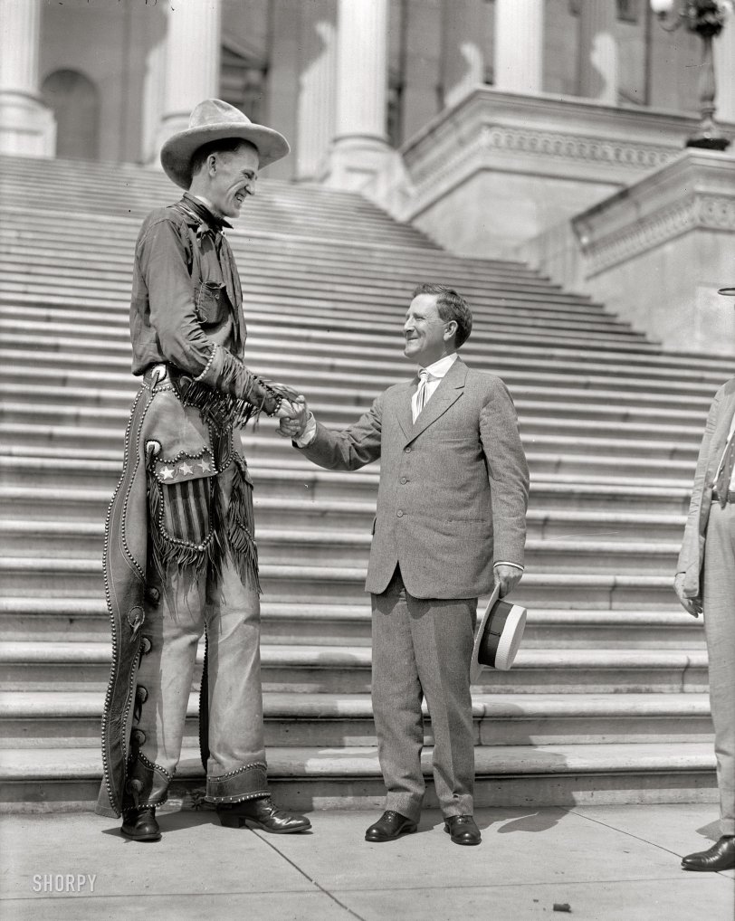 1919. "Ralph E. Madsen, the tall cowboy, shaking hands with Senator Morris Sheppard at Capitol." Harris &amp; Ewing Collection glass negative. View full size.
