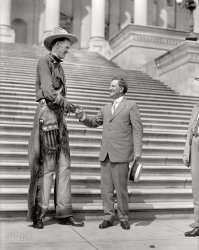 1919. "Ralph E. Madsen, the tall cowboy, shaking hands with Senator Morris Sheppard at Capitol." Harris & Ewing Collection glass negative. View full size.