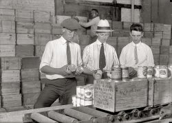 Washington, D.C., 1919. "Buying Army surplus food sold at fish market." Harris &amp; Ewing Collection glass negative, Library of Congress. View full size.
I hate canned peas!I hope that the million boxes behind the men are not also full of canned peas. Yuck!
Re: I hate canned peas!I hope for whirled peas.
Hate canned peas?I think they're Pretty Good.
Peas TreatyGray Hat: "Peas? I thought it was s'posed to be peace."
White Hat: "Yeah! They told us when the war was over we'd have peace. If I'd'a known they meant peas I'd'a stayed home."
Skinny Tie: "I slogged my way across France for a buncha peas?"
Warehouse Man: "Knuckleheads."
Best Headline EverHa! War and Peas. Fantastic.
I don&#039;t mean goober peasIn 1960 I was in junior high school with a kid from Austria whose family lived through the Allied occupation of Vienna. Food was rationed. He said that from the Russians they got nothing, from the Brits it was mutton, the Americans gave them everything, but the French give them peas!
The Russians themselves were probably eating 1919 surplus peas.
Give peas a chanceCould be worse. Could be brussels sprouts.
Hey, nowWatch it DoninVA...goober peas are normally a healthy and tasty treat. This recent kerfluffle about tainted goober peas is enough to make a fellow embarassed to sign his epistles.
Give (goober) peas a chance!
Goober Pea
I think I ate some of those peas!I think I know what those peas were like. They were huge and starchy and nothing like those deep green frozen peas people eat so many of now. Kids at military schools (not military academies, but public schools on military bases, for the children of active-duty parents) were served billions of those peas with school lunch. I don't really think the ones I ate in the early '60s came from 1919, but I would bet they had been around for quite a while! Being a total vegetable lover, I not only ate mine, but traded away all of my rolls, cakes and cookies for classmates' peas (as well as other vegetables).  I was very popular for sitting by at lunch! 
Canned PeasNever a good thing. Starchy and mushy. Part of it is the way that they're treated during the canning process and part is that they're allowed to wait a long time before processing. 
Frozen peas on the other hand are a marvel in part because they're frozen quickly after being picked. The longer a pea goes between picking and eating the more the natural sugars convert into starch. Freezing halts the process. Thus the peas you buy in the freezer section of the supermarket sometimes taste better than the ones you buy at the local farmers market. I know that some professional chefs who object to just about all frozen or processed ingredients make an exception for frozen peas.
(The Gallery, D.C., Harris + Ewing, Stores & Markets, WWI)