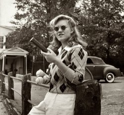 October 1943. Washington, D.C. A Woodrow Wilson High School student waiting to use the tennis court. View full size. Photograph by Esther Bubley.
