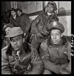 332nd Fighter Group airmen at a briefing in Ramitelli, Italy. March 1945. Foreground: Emile G. Clifton of San Francisco and Richard S. "Rip" Harder of Brooklyn. View full size. Photograph by Toni Frissell.