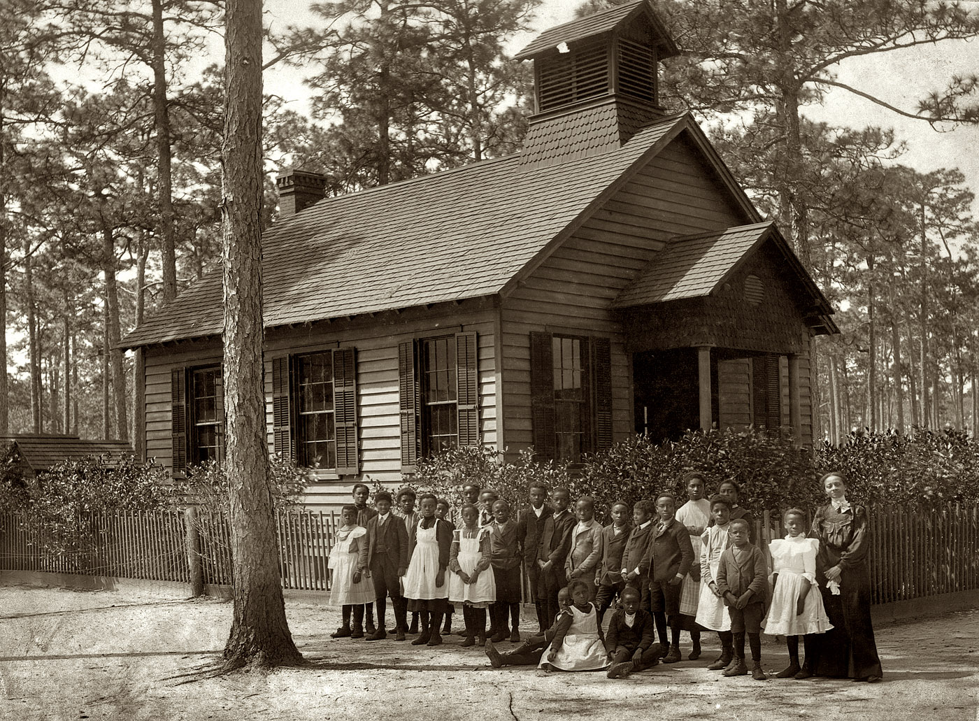 A schoolhouse, schoolmarm and students circa 1905, "possibly in South Carolina." View full size. Gelatin silver print by Detroit Publishing.