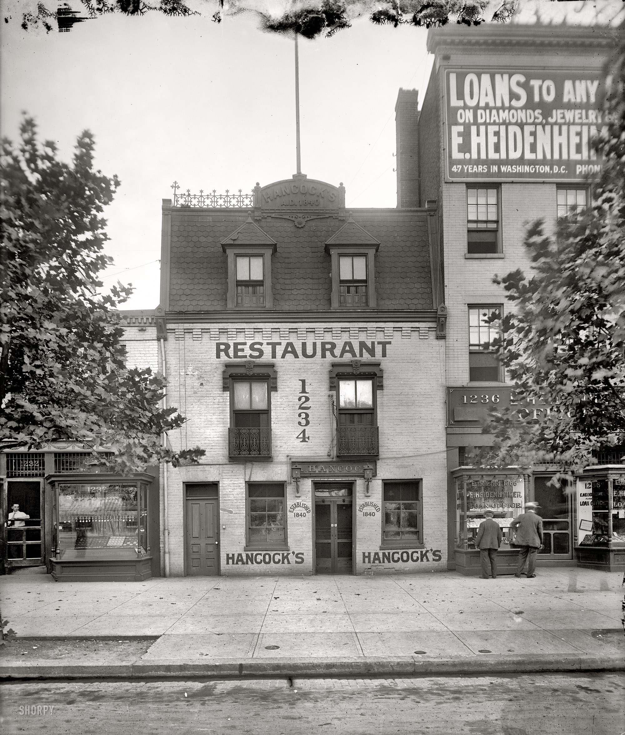 "Hancock's, the Old Curiosity Shop, 1234 Pennsylvania Avenue," probably around 1914, the final year of its existence. The restaurant, the Washington Post reported in 1927, "was noted particularly for two things -- its cocktails and its fried chicken." Harris & Ewing Collection glass negative. View full size.