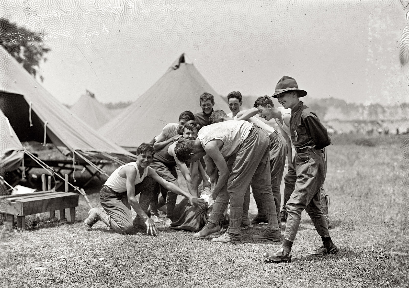 Boy Scouts at Gettysburg circa 1913 performing the time-honored camp ritual of water bucket to the head. View full size. George Grantham Bain Collection.