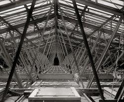 In political reportage there's a lot written about the House floor, but what about the ceiling? From 1925, a topside view of the House of Representatives in the U.S. Capitol. National Photo Company Collection glass negative. View full size.
Pics of the ceiling from the inside?Great pic of the wiring in the ceiling;  it was obviously taken to document the work.  Looks like they just needed to screw in the bulbs.  Any photos of this from the occupied space underneath?
[This was one in a series of photos taken to document Capitol artist Charles Moberly installing a translucent panel depicting the state seal of New Mexico. Illumination of the House chamber was by skylight, with electric lights above the skylights for supplementary illumination. - Dave]

(The Gallery, D.C., Natl Photo)