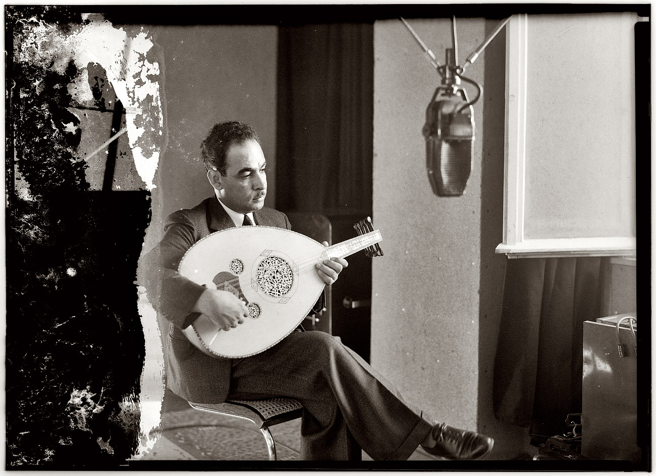 Oud player at the Palestine Broadcasting Service studios in Jerusalem circa 1940 during the British Mandate. View full size. 5x7 acetate, Matson Photo Service.