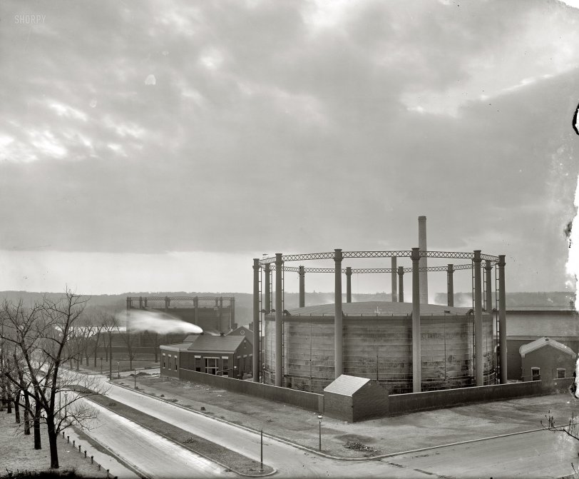 Washington, D.C., circa 1917. "Washington Gas Light holders at  26th and G streets N.W." These relics of the gaslight era ("two of Washington's biggest stinkers") were scrapped around 1947. Just about every city of any size in the latter half of the 19th century had its "gashouse district" -- a rough neighborhood dominated by smelly holding tanks for the municipal gas plant, where coal was gasified to make "city gas" (generally either "coal gas" or "water gas," depending on the process) for illumination. Harris &amp; Ewing Collection glass negative. View full size.
