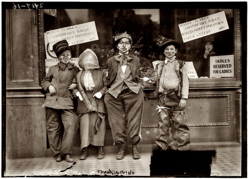 Thanksgiving maskers outside a restaurant circa 1911, when a turkey dinner with all the fixings was 40 cents. View full size. George Grantham Bain Collection.
