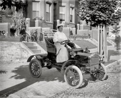 Washington, D.C., circa 1908. "Mrs. Guy Henry in auto." Which our readers have identified as a Maxwell Tourabout. Harris &amp; Ewing glass negative. View full size.
Maxwell TouraboutIt's a Maxwell Tourabout. Maxwell and Brush were part of the same company.

I&#039;m thinkingit is NOT a 1969 Cougar. A friend of mine had one and I remember the fenders being sportier.
Auto PlantIs that a plumeria on the porch? If so, I am somewhat surprised to see it in D.C. 
Early WheelsI'm guessing it's a 1908 Brush Runabout... or perhaps an earlier model B Cadillac.
BrushyIt has the same little plaque on the radiator showing a car as on some Brush roadsters I found on the Web.

&#039;08 BrushI believe this may be a new 1908 Brush. Note the lack of headlights mounted in the front.
Locked trunksI don't know, but I want one. Did anyone ever figure out why they overprotected the trees so much? Were cars that apt to bump into them?
[Horses tended to nibble on them. - Dave]
The MaxwellThe Maxwell was the first car to be driven across America by a woman, Alice Huyler Ramsey, in 1909. It got the job done.
CSI: ShorpyIt's time for Shorpyists to take it to the next level. You can ID plants, animals, cars and ephemera, let's move to fingerprint analysis of the marks left on this photo.
MaxwellIf it was a Maxwell, shouldn't it have the Maxwell script on the radiator?
[Noop. There wasn't any. - Dave]
1905 Maxwell Model L Tourabout1905 was the first year for Maxwells (some sold in late 1904 as 1905 models); this is the little one, the Model L. Two-cylinder opposed motor and with two-speed transmission and shaft drive in an era where final drive by chain was popular.
The small plaque up front is probably the radiator maker's plate; radiators for Maxwell and Brush may have been made by the same company. Maxwells had the name only on the hubcaps and threshold plates.  Some (and I think they were dealer installed later) had the Maxwell script over the front of the radiator.  Most period photos show only the nameless radiator but these cars had a very unique look  not to be confused with any other.
The Brush didn't come into the picture with Maxwell until 1910, when Benjamin Briscoe started his New United Motors, which included the Maxwell, Brush and several other makes.
A neat slogan was used by Maxwell: Perfectly Simple --  Simply Perfect.
It was a good little car.  I've had rides in several and they settle down to a nice lope.  Going uphill on one tour I hopped off and ran alongside.  Not a powerful car, these little Maxwells, but their larger two-cylinder Model H had ample power for an early, not too large, car.
Where isTweety Bird?
(The Gallery, Cars, Trucks, Buses, D.C., Harris + Ewing)